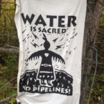 A sign at encampment near Pellston, Mich., where protesters are camping in opposition to the Line 5 pipeline project - THE BLADE-TOM HENRY