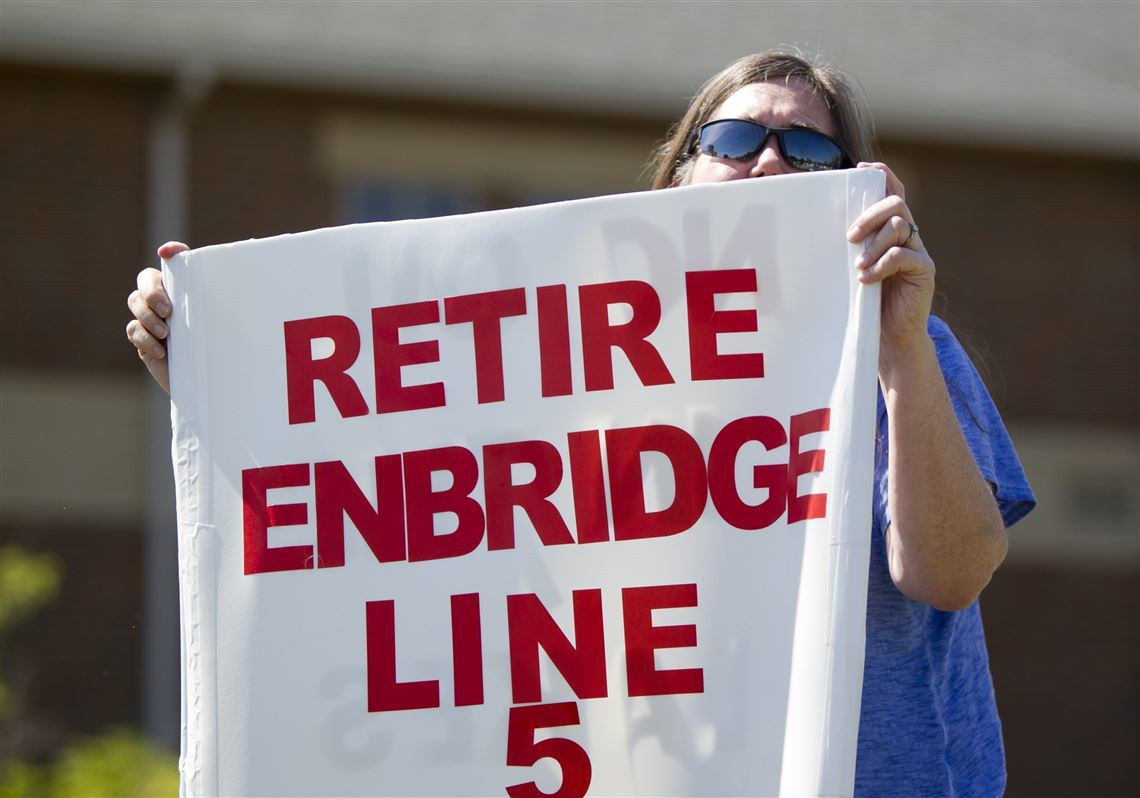 Lauren Sargent, takes part in a protest before the Enbridge Line 5 pipeline public information session in Holt, Mich. in 2017. - ASSOCIATED PRESS